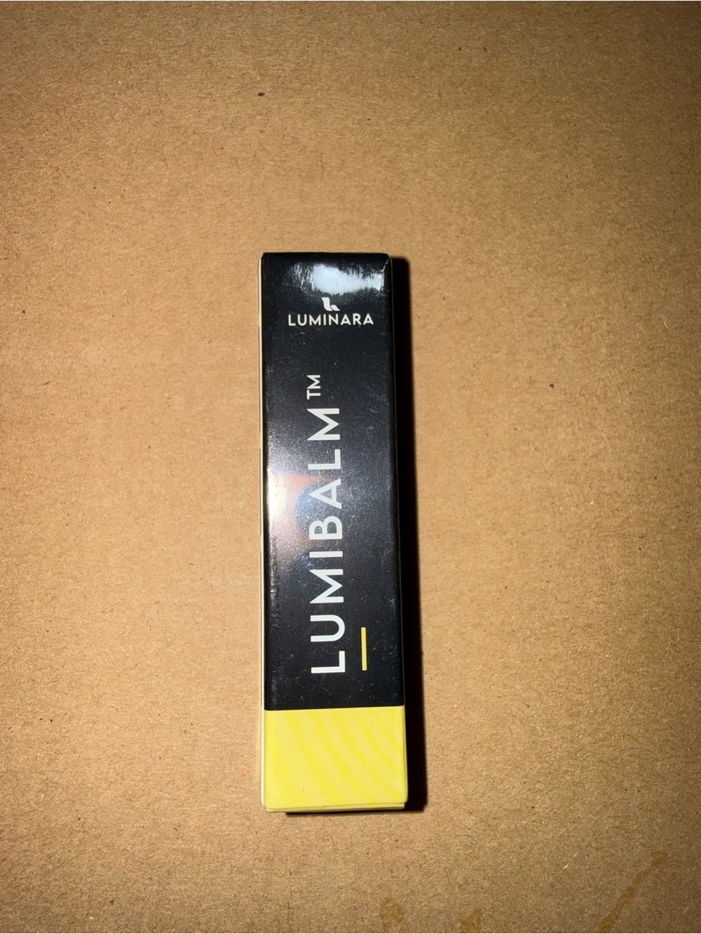 Luminara Lumibalm Lip Product in Yellow & Black Packaging